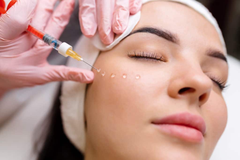 Esthetician Giving Filler Injection to Beautiful Woman | Vibe Aesthetics in Hood River, OR