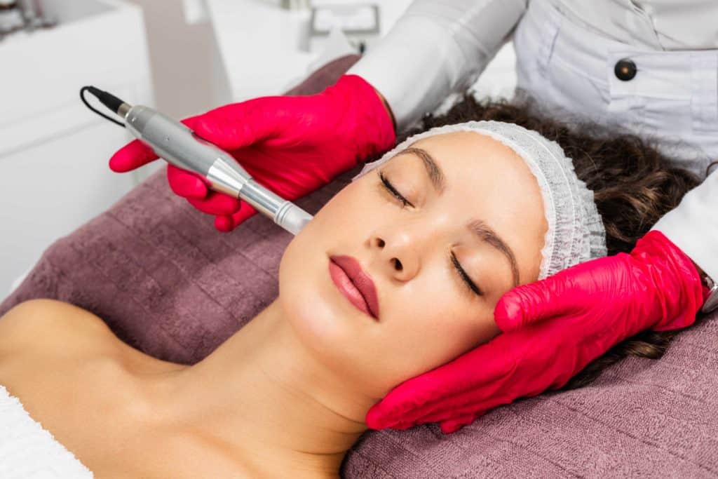 Esthetician Giving Microneedling Treatment to Young Woman | Vibe Aesthetics in Hood River, OR