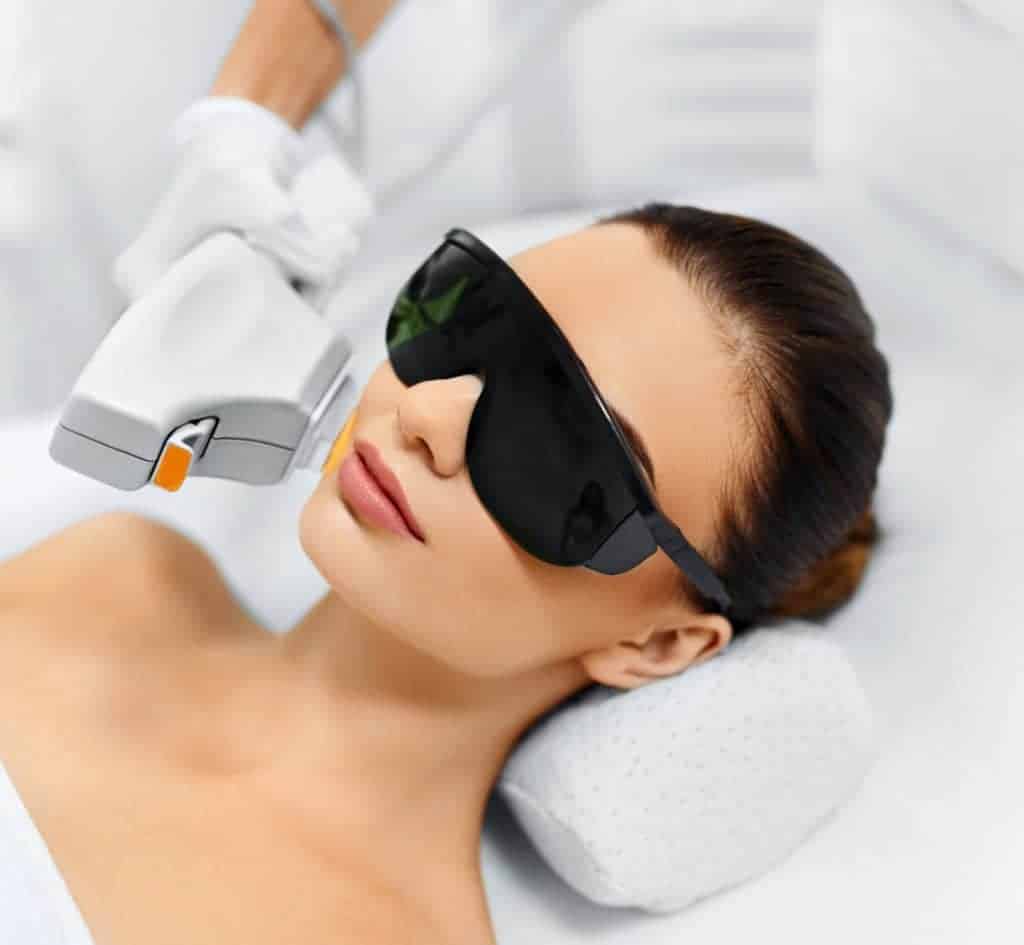Beautiful Woman Taking Laser Hair Removal Treatment By Wearing Black Googles | Vibe Aesthetics in Hood River, OR